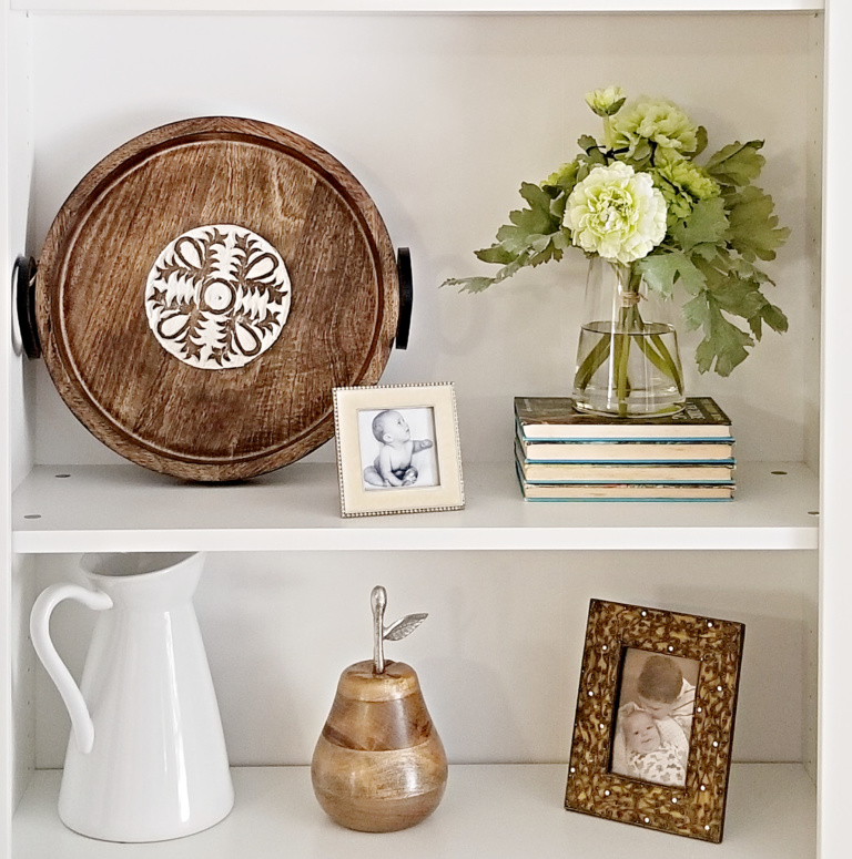 How to Style Bookcases on a Budget with trays and vases and picture frames