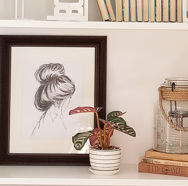 How to Style Bookcases on a Budget with charcoal sketch of a women