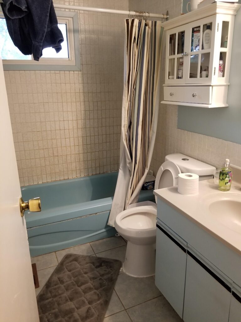 image of tub and surround before cottage style bathroom reno