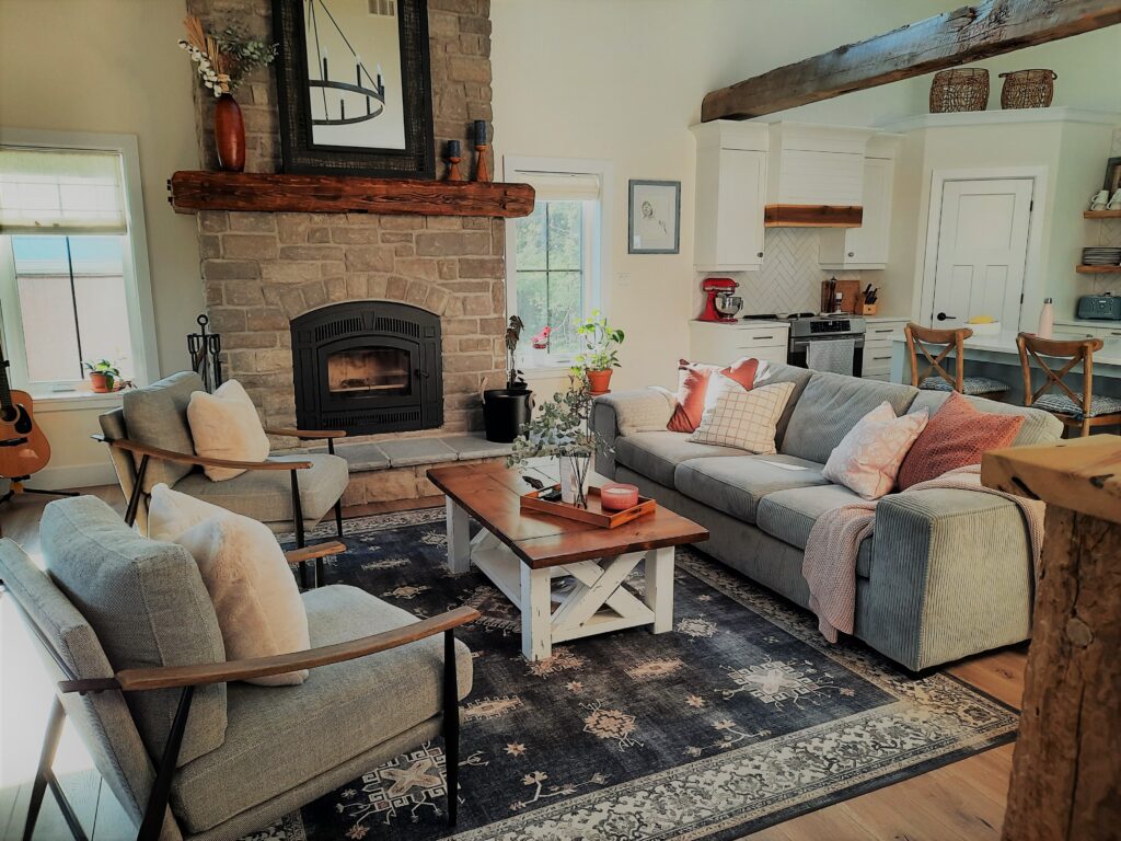 open concept farmhouse style living room with fire place cladded with Shale Stone in colour Hudson