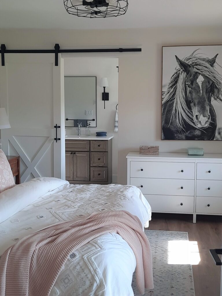 modern farmhouse master bedroom with casual cream, grey and soft pink bedding